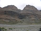 Tibet Kailash 08 Kora 16 Waterfall In Longevity Buddhas On the left (west) are three peaks known as the three longevity Buddhas: D�lma (Tara), Amitayus (Tib. Tsepagme) and Namgyalma (Tib. Vijaya). A long trailing waterfall spills between them, said to be Gesar�s saddle. Gesar is the hero-king of Tibet�s great epic story.